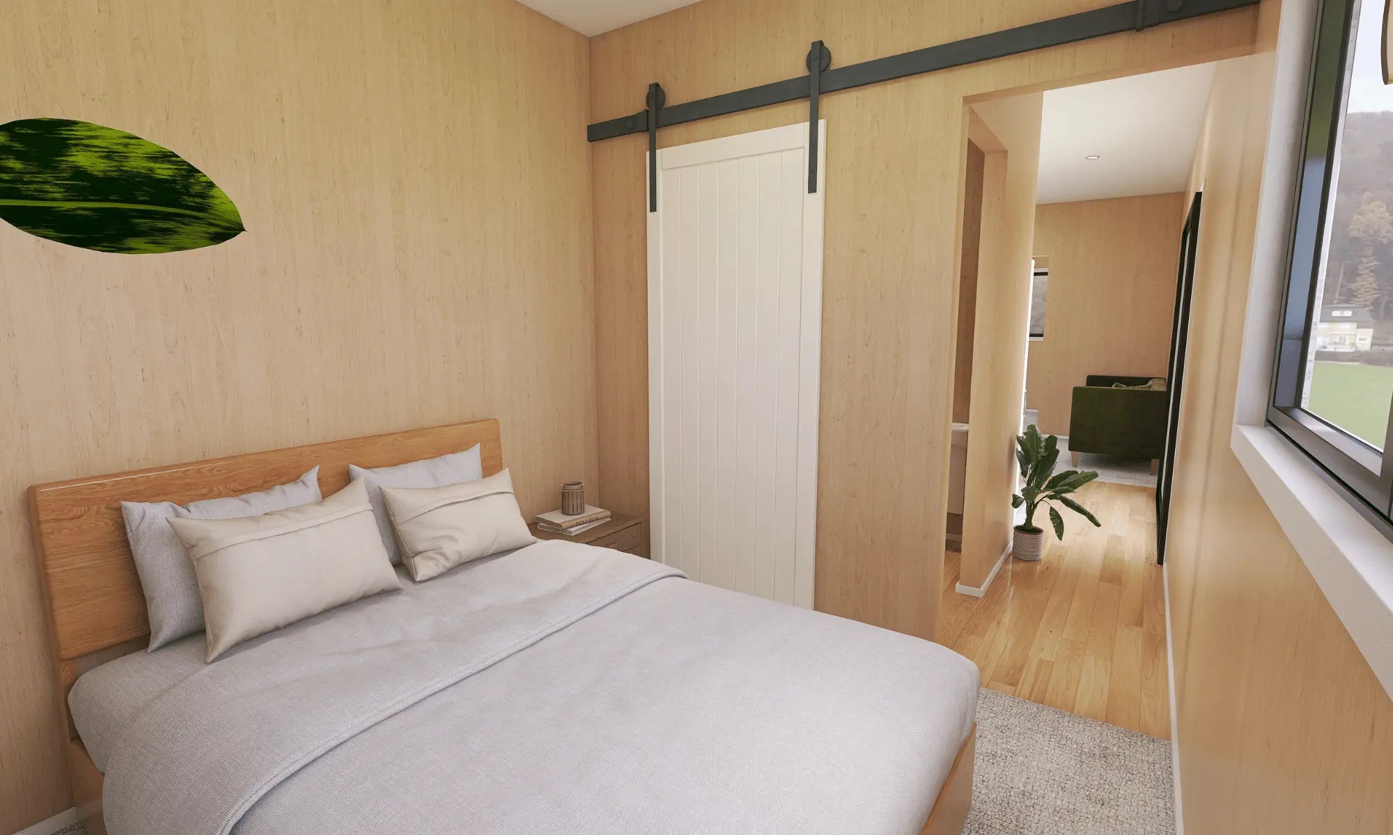 View of the master bedroom looking down the hallway and into the living/dining space. There is a bed in the middle of the room, along with a bedside table, white wooden sliding barn door and carpeted flooring. 